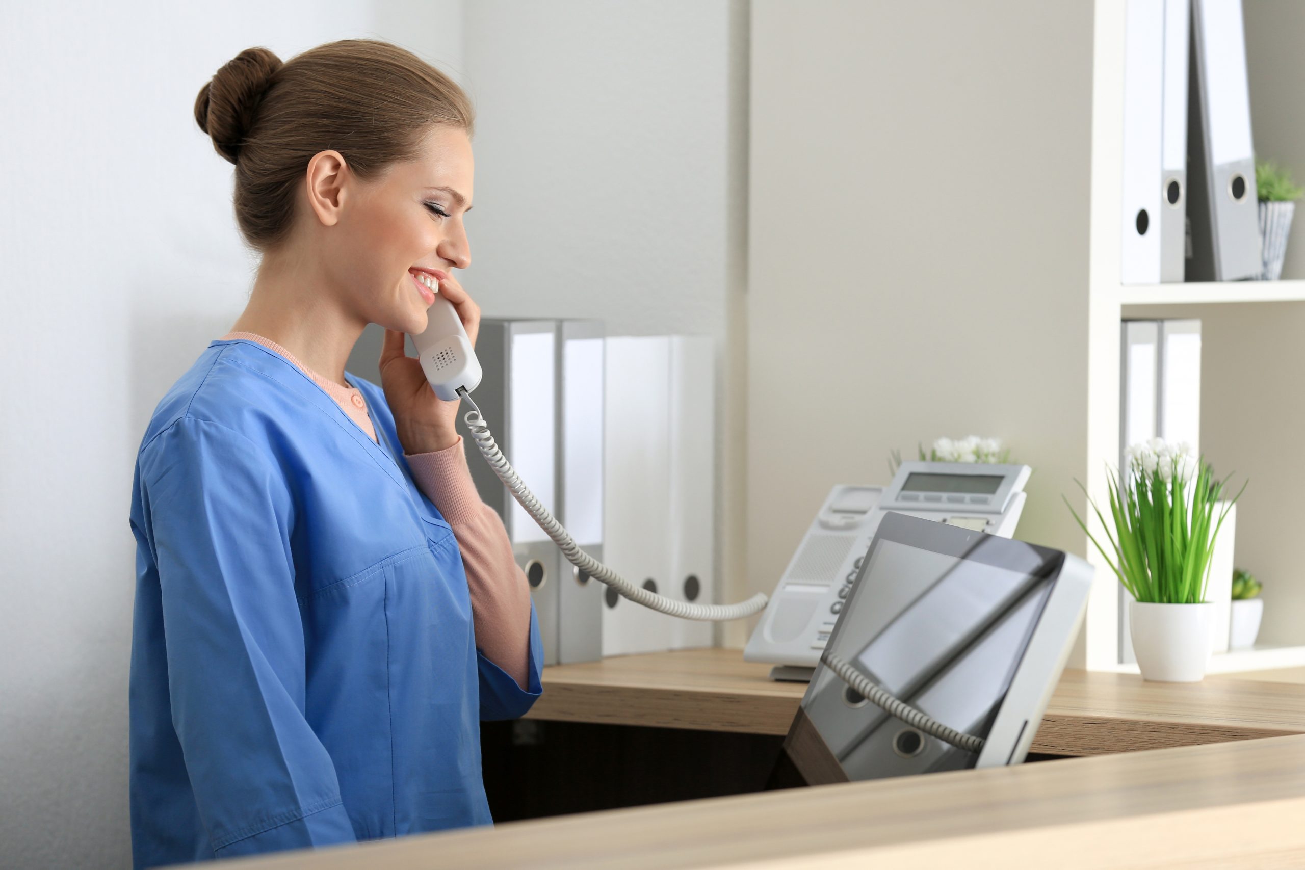 Front desk team member answering a patient call