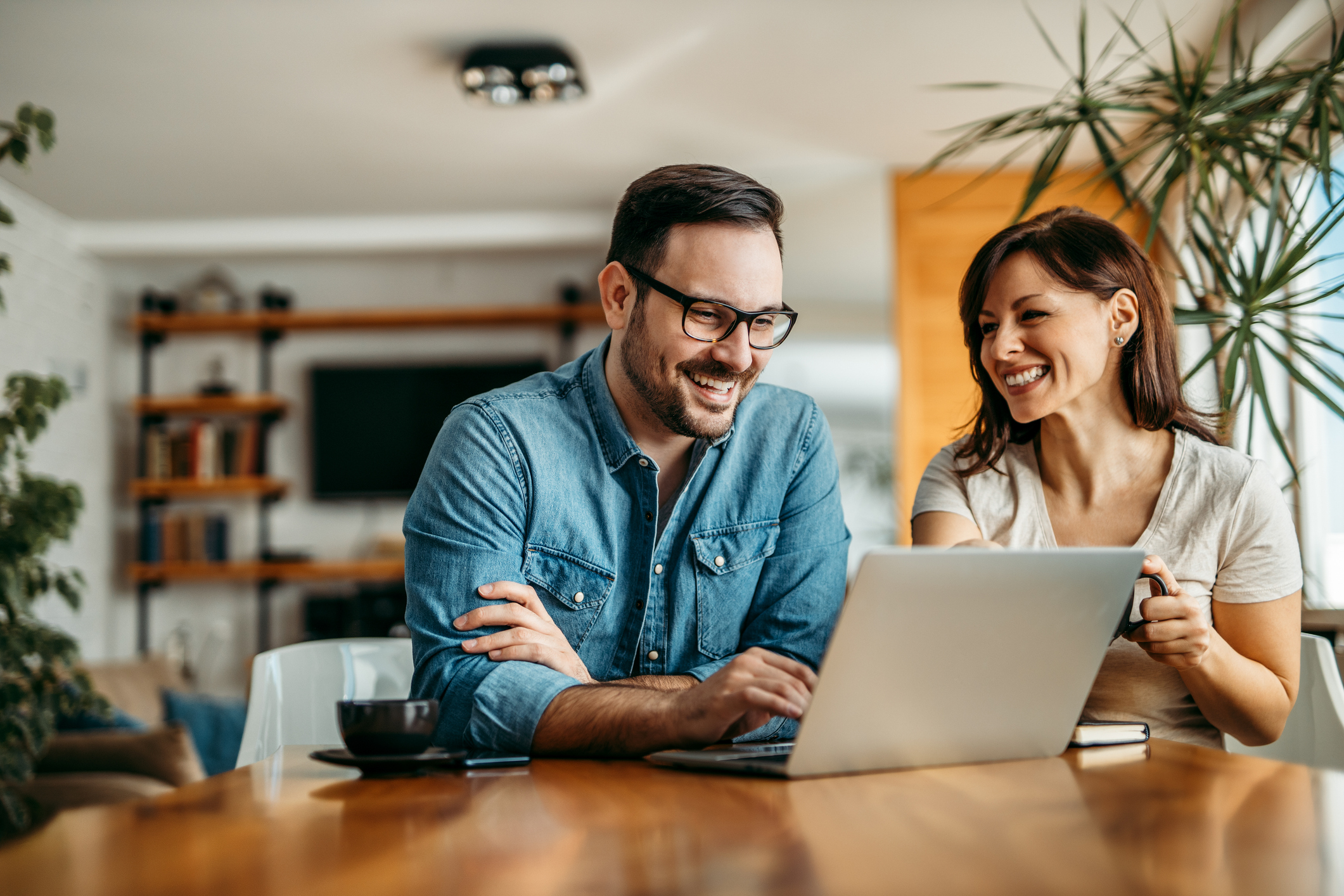 Couple at home looking over their family budget together